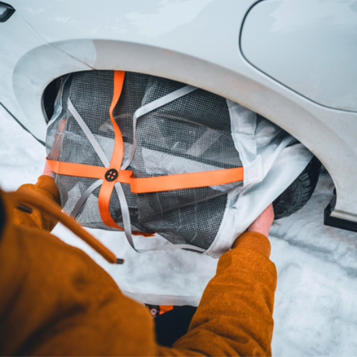 Installation process showing the first step of mounting AutoSock snow chains