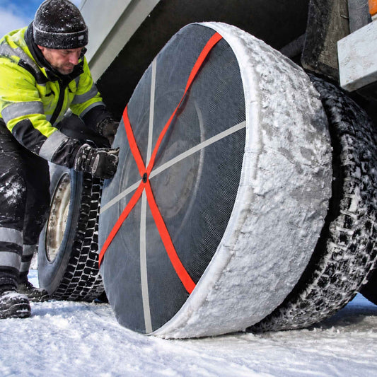 AutoSock mounted on rear wheels of a truck with a truck driver
