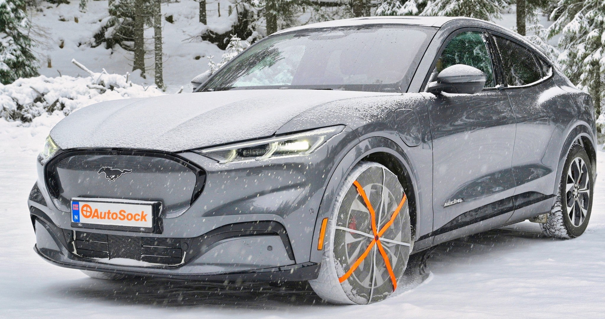 AutoSock mounted on front wheels of a Ford Mustang standing on snow