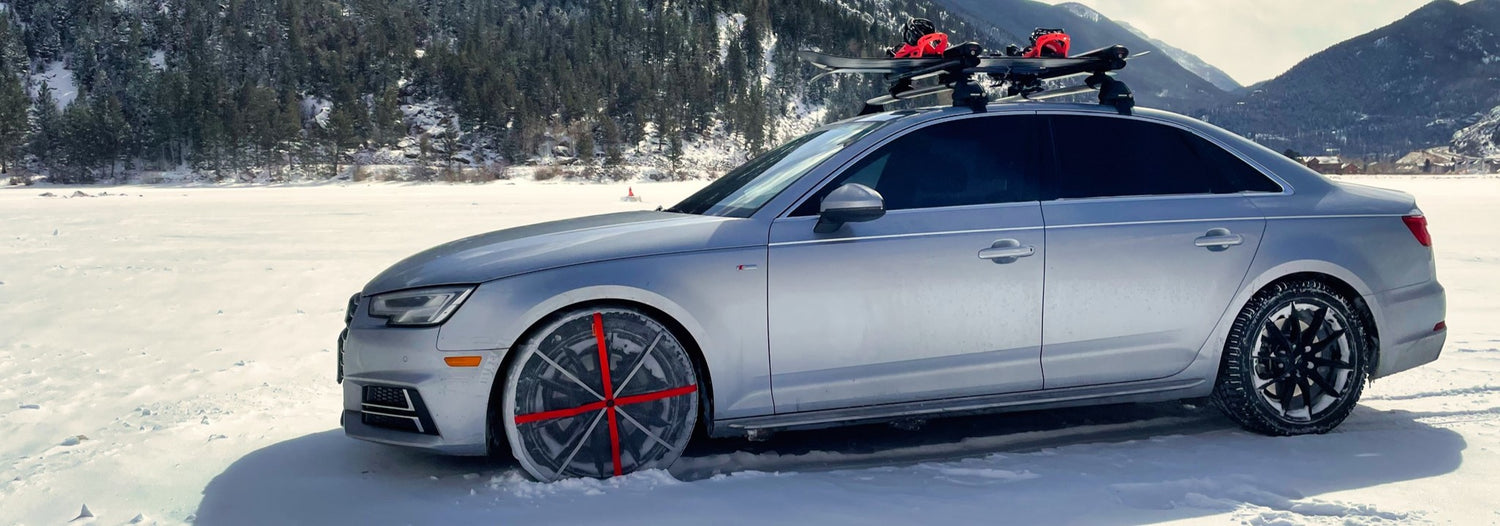 AutoSock tire socks mounted on passenger car in mountain region, standing on snow