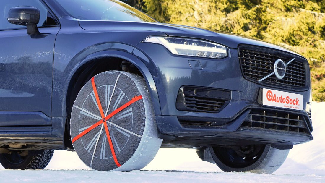 Textile tire chains mounted on front wheels of a Volvo SUV