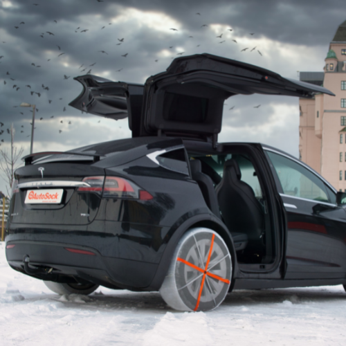 AutoSock assembled on rear wheels of a Tesla SUV
