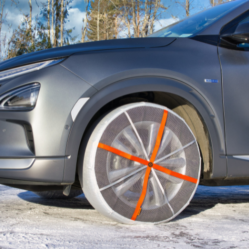 Snow Sock installed on front wheels of a SUV