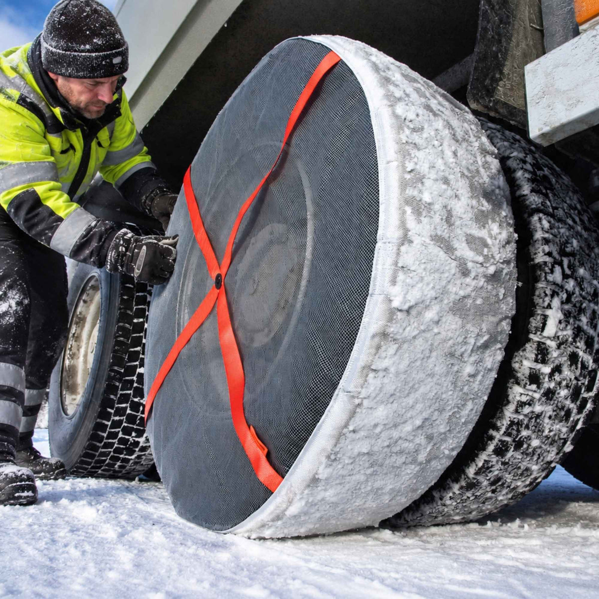 AutoSock mounted on rear wheels of a truck with a truck driver