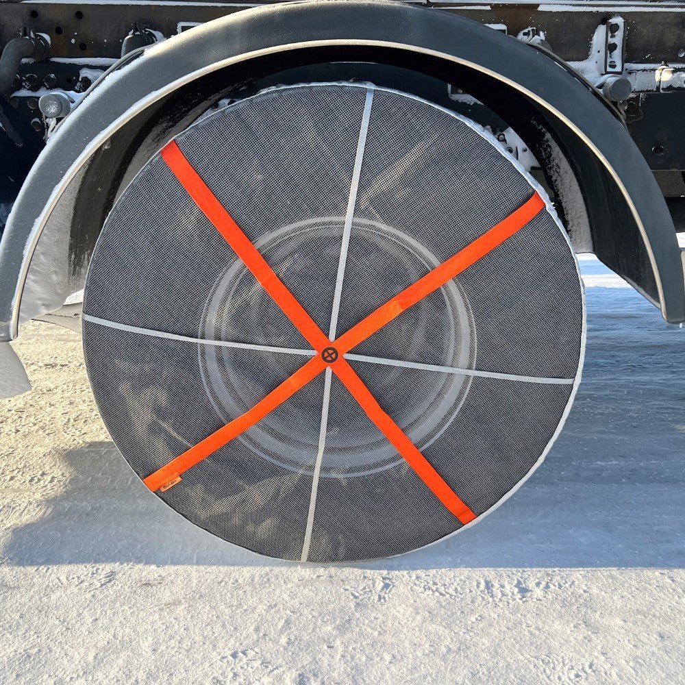 Snow socks being installed on a truck wheel (side view)