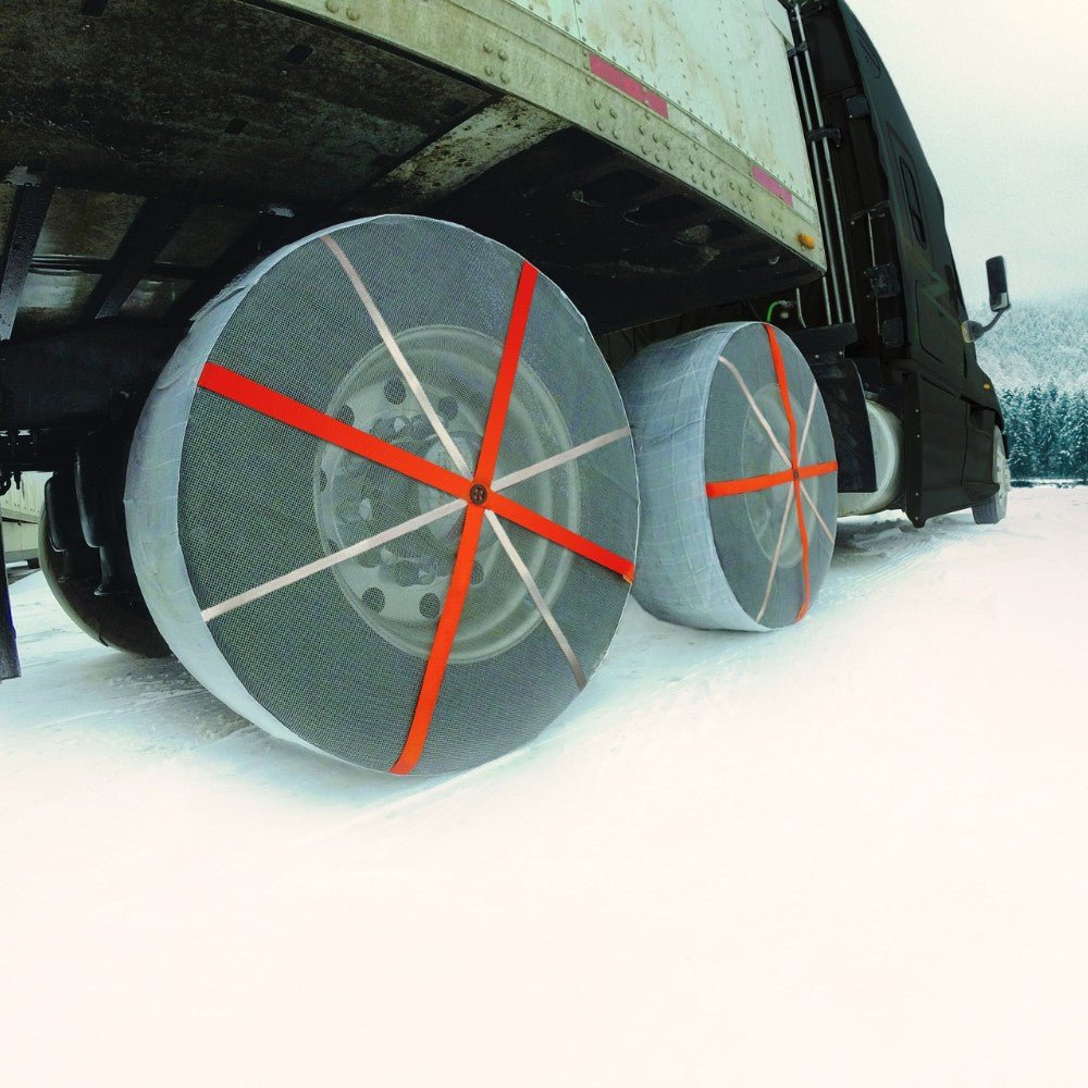 AutoSock mounted on truck wheels and driving on snow in winter landscape