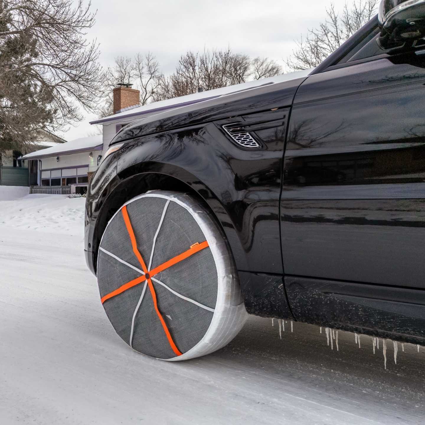 Driving SUV vehicle with textile snow chains mounted