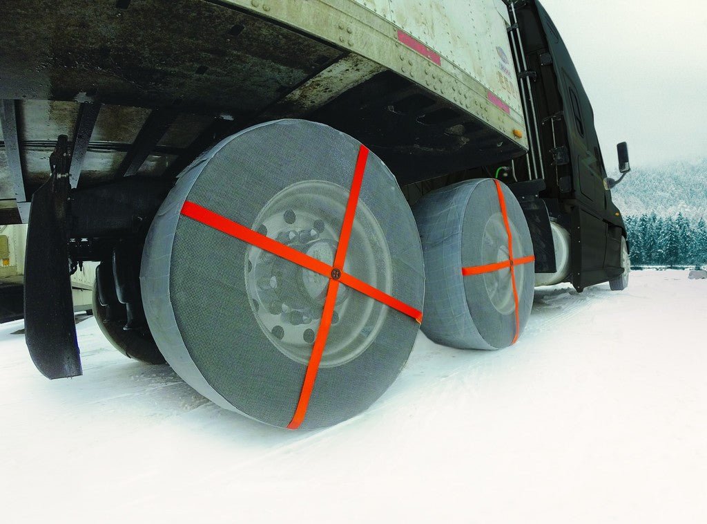 AutoSock mounted on truck wheels and driving on snow in winter landscape